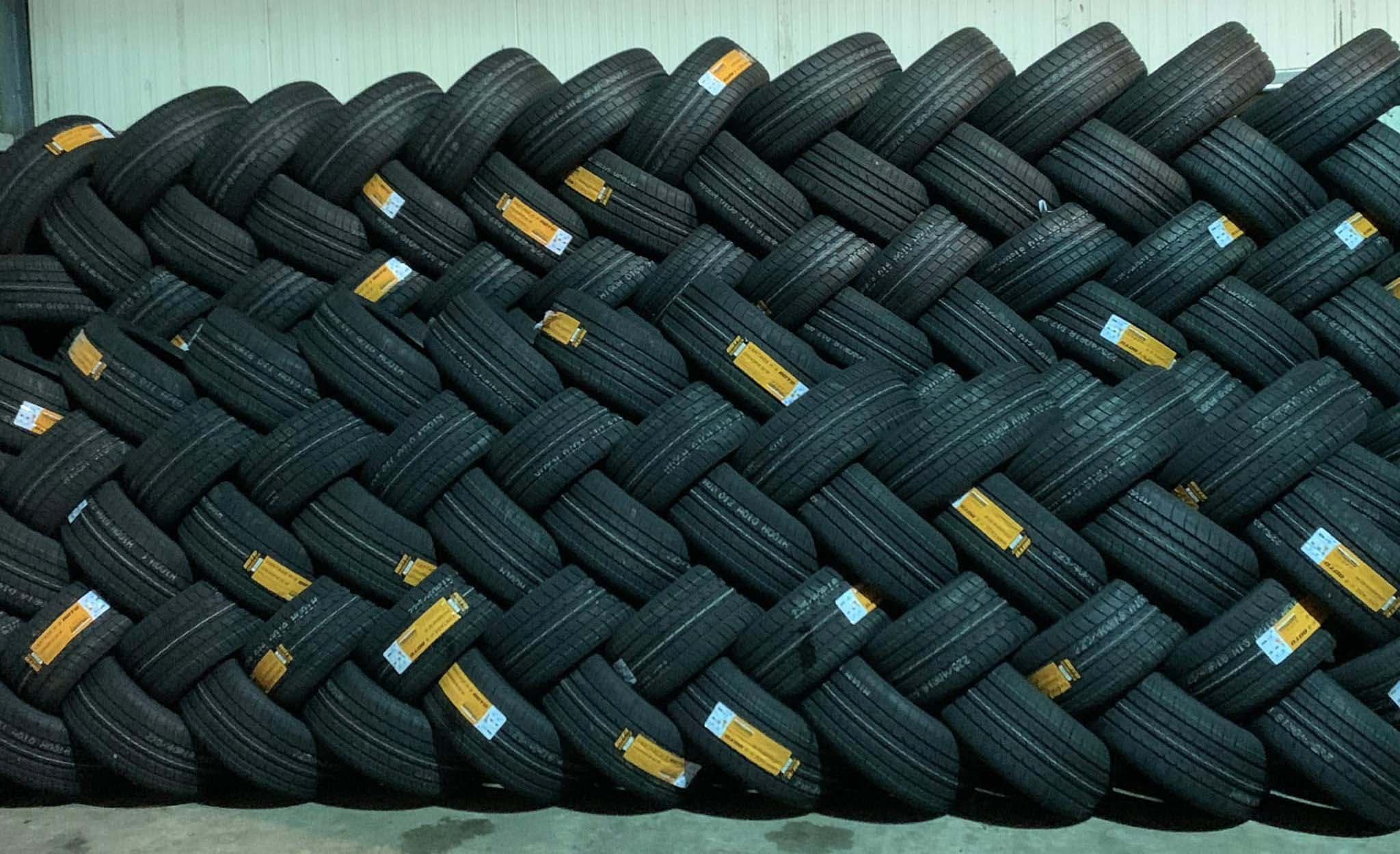 Tyres stacked against a wall