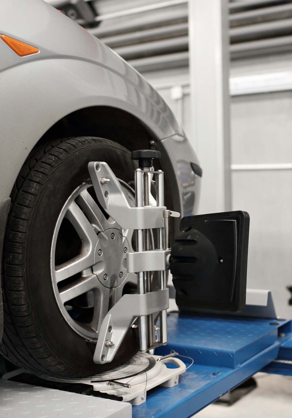 Grid sensor sets mechanic on auto. Car stand with sensors wheels for alignment camber check in workshop of Service station